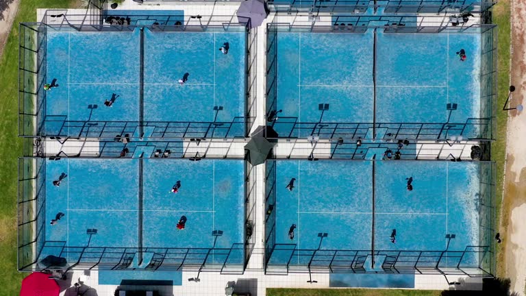 Above shot of two blue padel courts with players